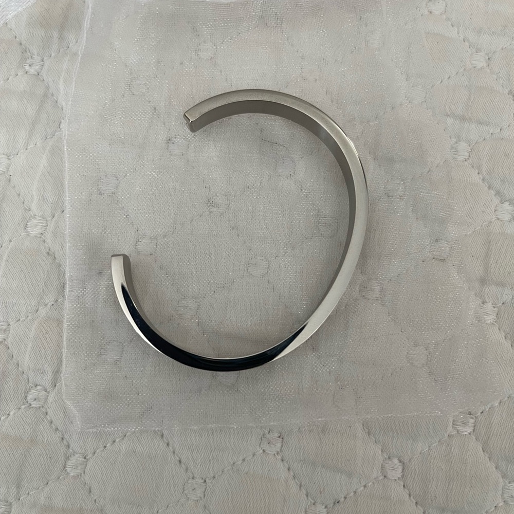 Plunder Silver Open Cuff Bracelet holds hair elastics